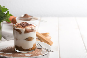 Tiramisu in a glass cup. Horizontal orientation with copy space