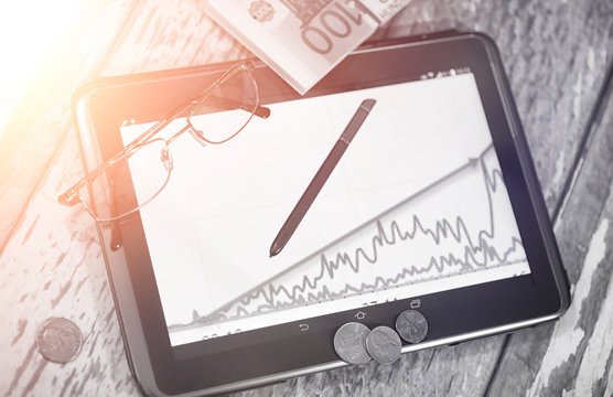 The graph of income growth. Electronic tablet with a graph of gr