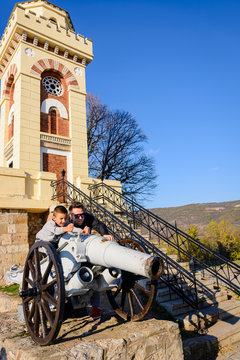 Man and child playing outside together on a cannon 