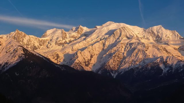 Mont Blanc mountain range. Timelapse from sunset to twilight. The view includes from left to right, Aiguille du Midi needle, Mont Blanc du Tacul and Mont Blanc. Chamonix, Haute-Savoie, Alps, France