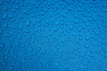 Rain drops on a blue smooth surface.