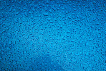 Rain drops on a blue smooth surface.