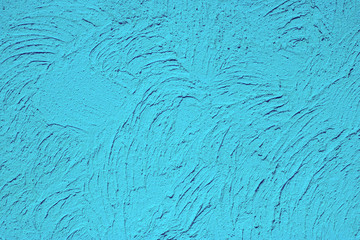 Background: texture of yellow decorative plaster on the wall