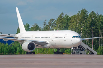 Commercial passenger airplane in the parking at the airport.