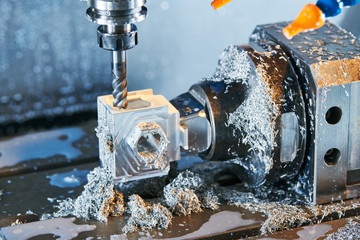 Milling metalworking process. Industrial CNC metal machining by vertical mill. Coolant and...