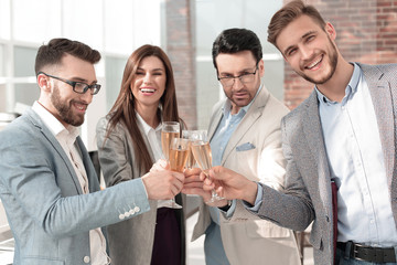close up.business team raises their glasses.