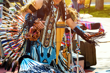 An Indian from South America dances in a national costume with feathers.