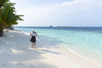 Asian girl walk on the beach