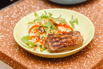 Beef steak with salad rice on a plate