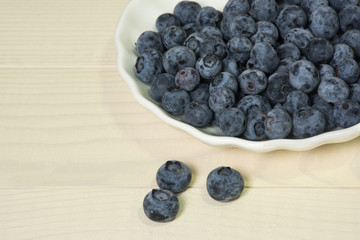 Blueberries summer berry on wooden table. Vitamin C, E, P, PP, B carotene flavonoids ascorbic acid. Organic fresh antioxidant food