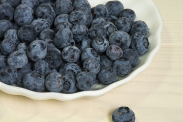 Blueberries summer berry on wooden table. Vitamin C, E, P, PP, B carotene flavonoids ascorbic acid. Organic fresh antioxidant food