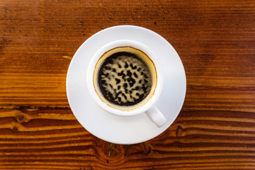 white cup of hot coffee on table