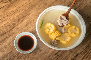 Corn bone soup, wood grain background