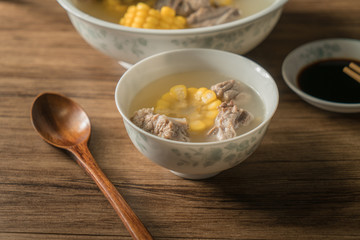 Corn bone soup, wood grain background