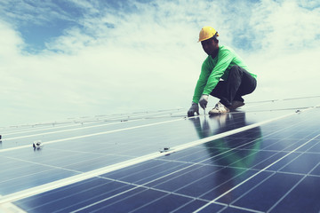 Fototapeta na wymiar engineer team working on replacement solar panel in solar power plant;engineer and electrician team swapping and install solar panel after solar panel voltage drop