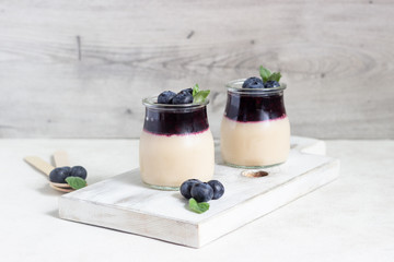 Coffee panna cotta with berry coulis and fresh blueberries. Delicious Italian dessert panna cotta