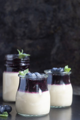 Coffee panna cotta with berry coulis and fresh blueberries. Delicious Italian dessert panna cotta