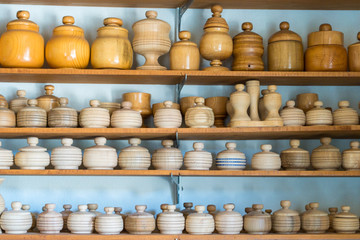 Fototapeta na wymiar Group of wooden pot and jar for vegetable and food on shelf. Closeup.