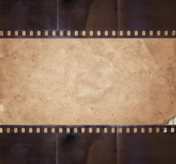 Vintage background with aged paper and old film strip