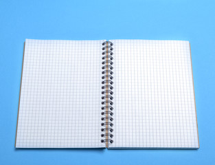open blank notebook in a box on a blue background