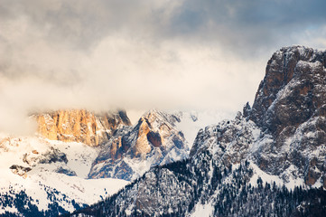 Mountain peaks in the clouds at sunset, Dolomites, Italy