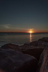 Sunset over Lake with a Rock Shoreline