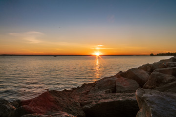 Sunset over Lake with a Rock Shoreline