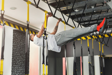 Man doing pull up exercise on horizontal bar