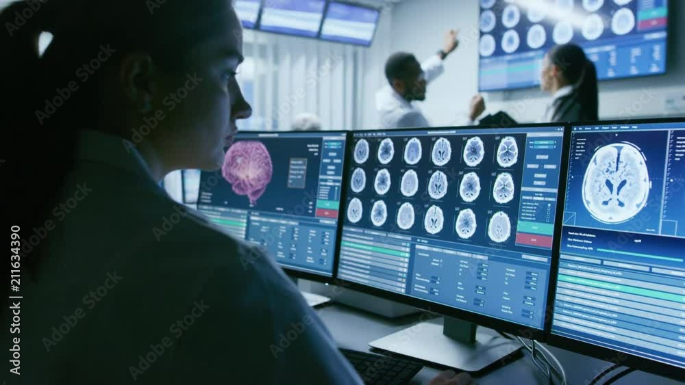 Poster over the shoulder shot of female medical scientist working with ct brain scan images on a personal c