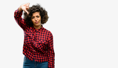 Beautiful arab woman showing thumbs down unhappy sign of dislike, negative expression and disapproval