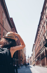 Girl walking in the main way of Bologna in a sunny day - Travel in Italy