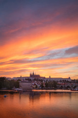 Fototapeta na wymiar Vertical view on Prague gothic Castle with Charles Bridge after the sunset, Czech Republic - Beautiful reflections of Vltava river and clouds