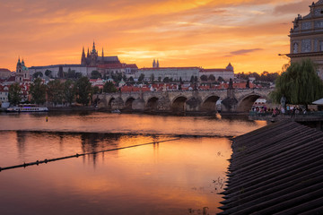 Obraz na płótnie Canvas The View on Prague gothic Castle with Charles Bridge after the sunset, Czech Republic - Beautiful reflections of Vltava river