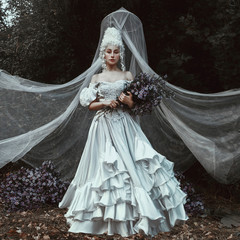 Beautiful girl is posing in a Middle Ages historical dress