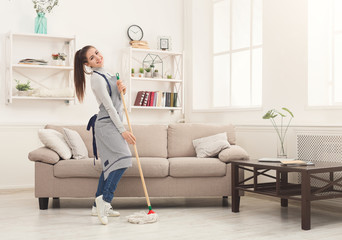 Happy woman cleaning home with mop and having fun