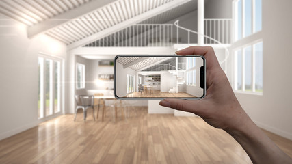 Hand holding smart phone, AR application, simulate furniture and interior design products in real home, architect designer concept, blur background, modern living room with kitchen - obrazy, fototapety, plakaty