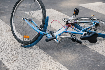 Blue child's bicycle on a pedestrian lines after traffic incident