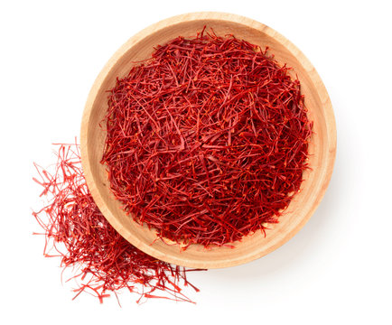 saffron thread in the wooden bowl, isolated on white background, top view
