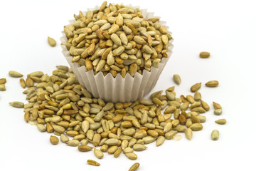 fresh sunflower seeds in paper cup isolated on a white background