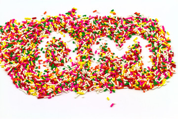 Decorative sprinkles sugar in alphabet shape as DM  on  white background