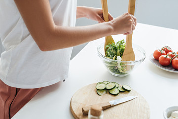 cropped shot of woman preparing delicious healthy salad