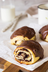 Sweet roll buns with poppy seeds covered with chocolate glaze