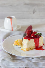 Piece of delicate cheesecake with strawberries sauce on a white plate. 