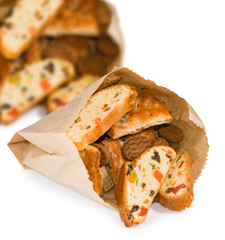 image of sweet rusks with candied fruits and cookies on white background