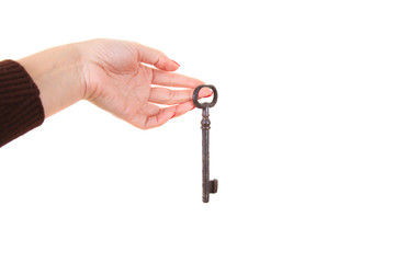 A female hand holds a large old key.