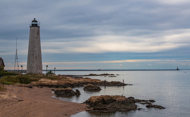 Fototapeta na wymiar Lighthouse with beach and fisher men