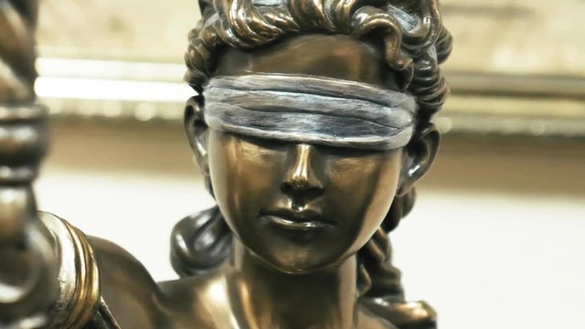 Themis bronze statue face close up