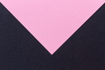 Close-up of a pink and black paper letter envelope with a handmade look. Horizontal view.