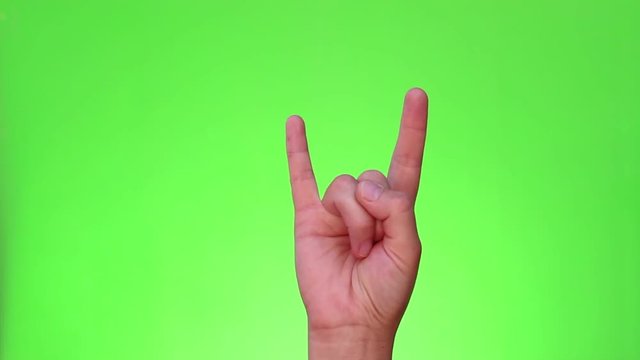 Sign of the horns. A "rock on" hand gesture. Heavy Metal. Chromakey. Green Screen. Isolated