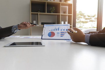 Businessmen present earnings report , the monthly college budget, financial chart to colleagues in the meeting.